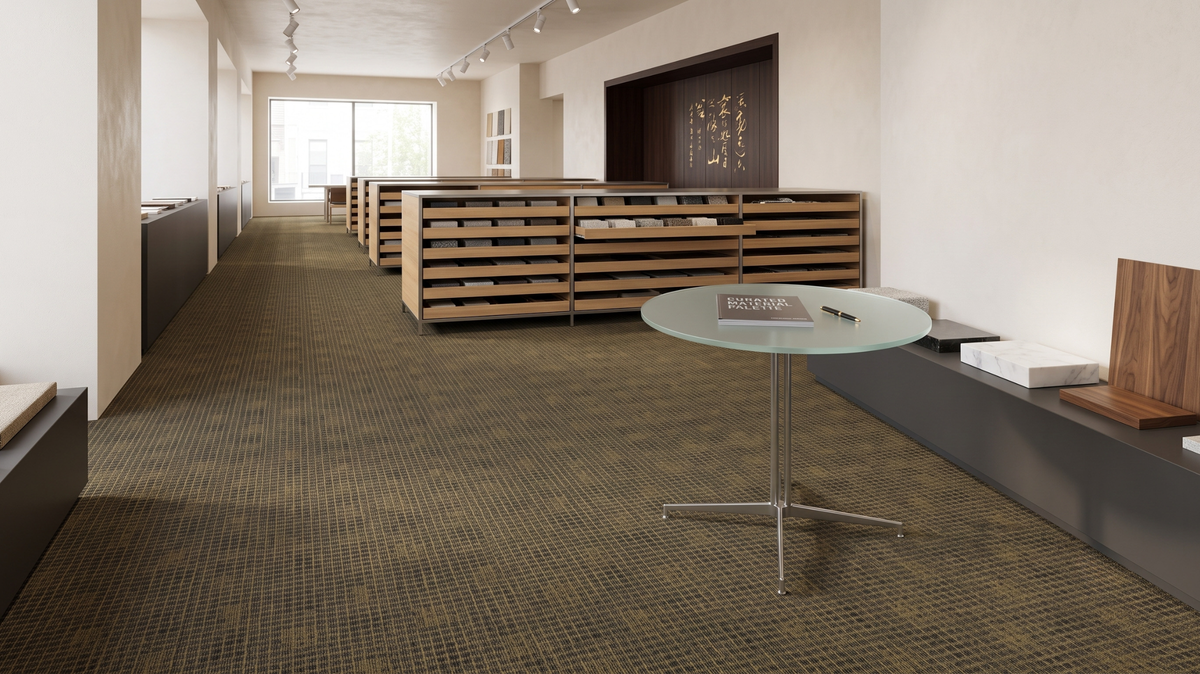 Wool and solution-dyed nylon carpet samples compared in a Singapore flooring showroom