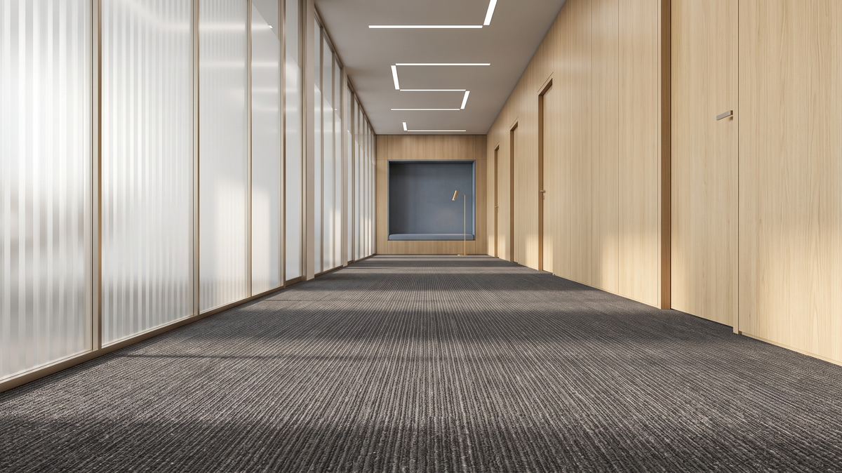 Oyster grey carpet tiles with one damaged tile being replaced in a Singapore office corridor