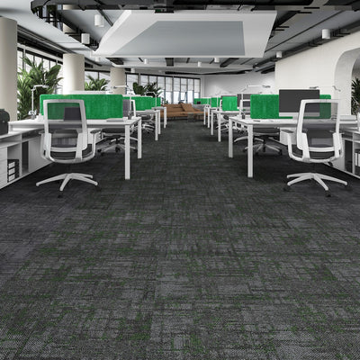 Office meeting area with green chairs and dark carpet flooring